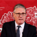 Red political infographic showing a man in a suit speaking, with a jagged line graph and the labels '2024 General Election', 'Unfavourable 69%', and '44%'; conveys unfavorable poll ratings and election context.